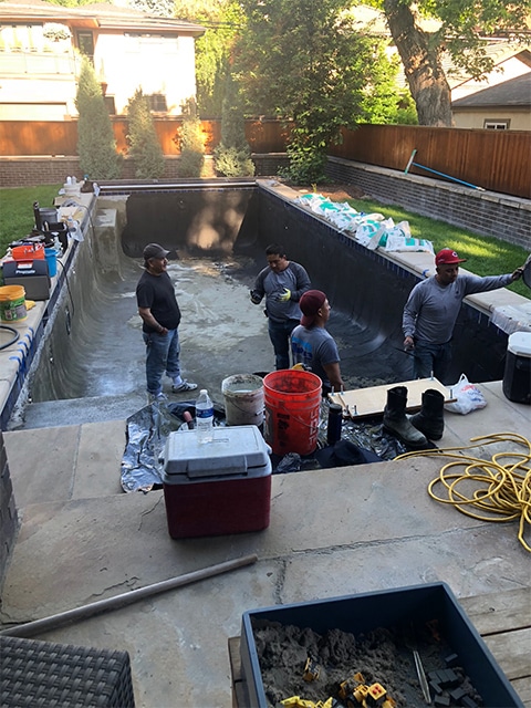 Lots of workers renovating this pool